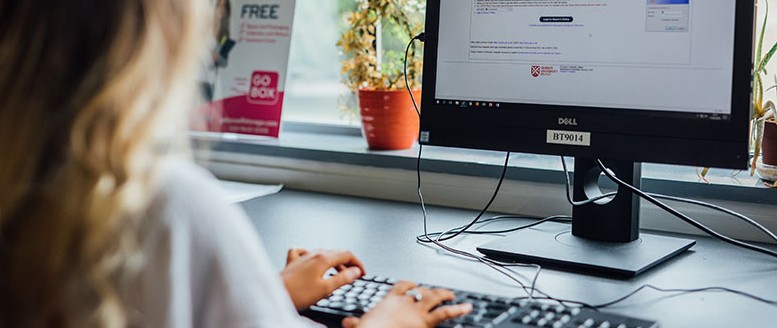 Student typing on keyboard